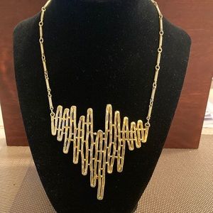 Gold tone wave length statement necklace